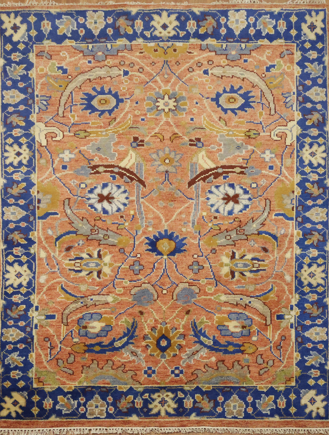 Intricate Floral Orange Rug with Vibrant Blue Border Accent 5'x7'