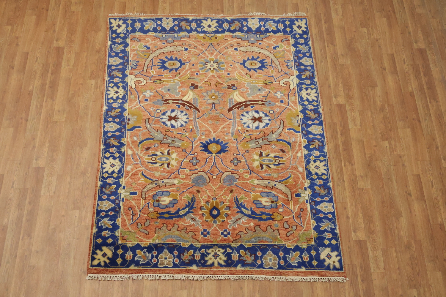 Intricate Floral Orange Rug with Vibrant Blue Border Accent 5'x7'