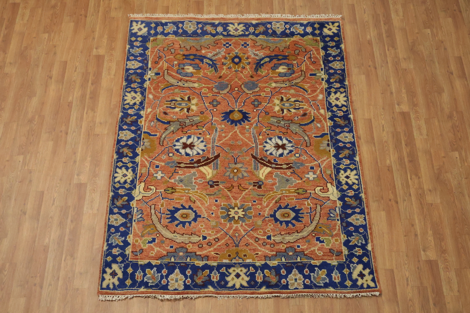 Intricate Floral Orange Rug with Vibrant Blue Border Accent 5'x7'