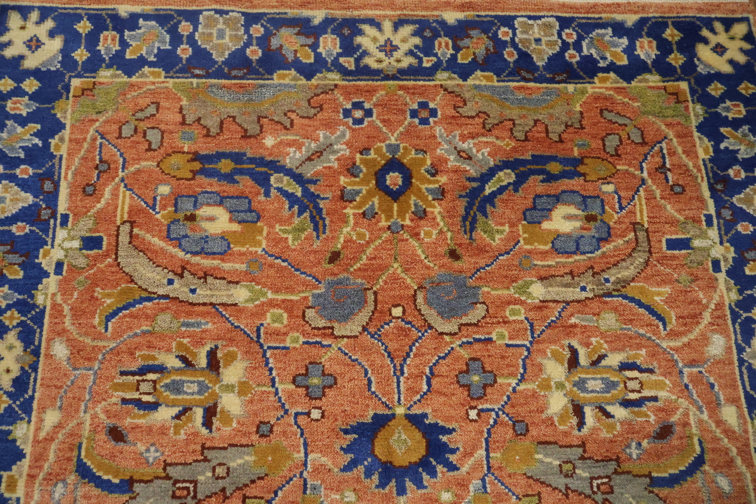 Intricate Floral Orange Rug with Vibrant Blue Border Accent 5'x7'