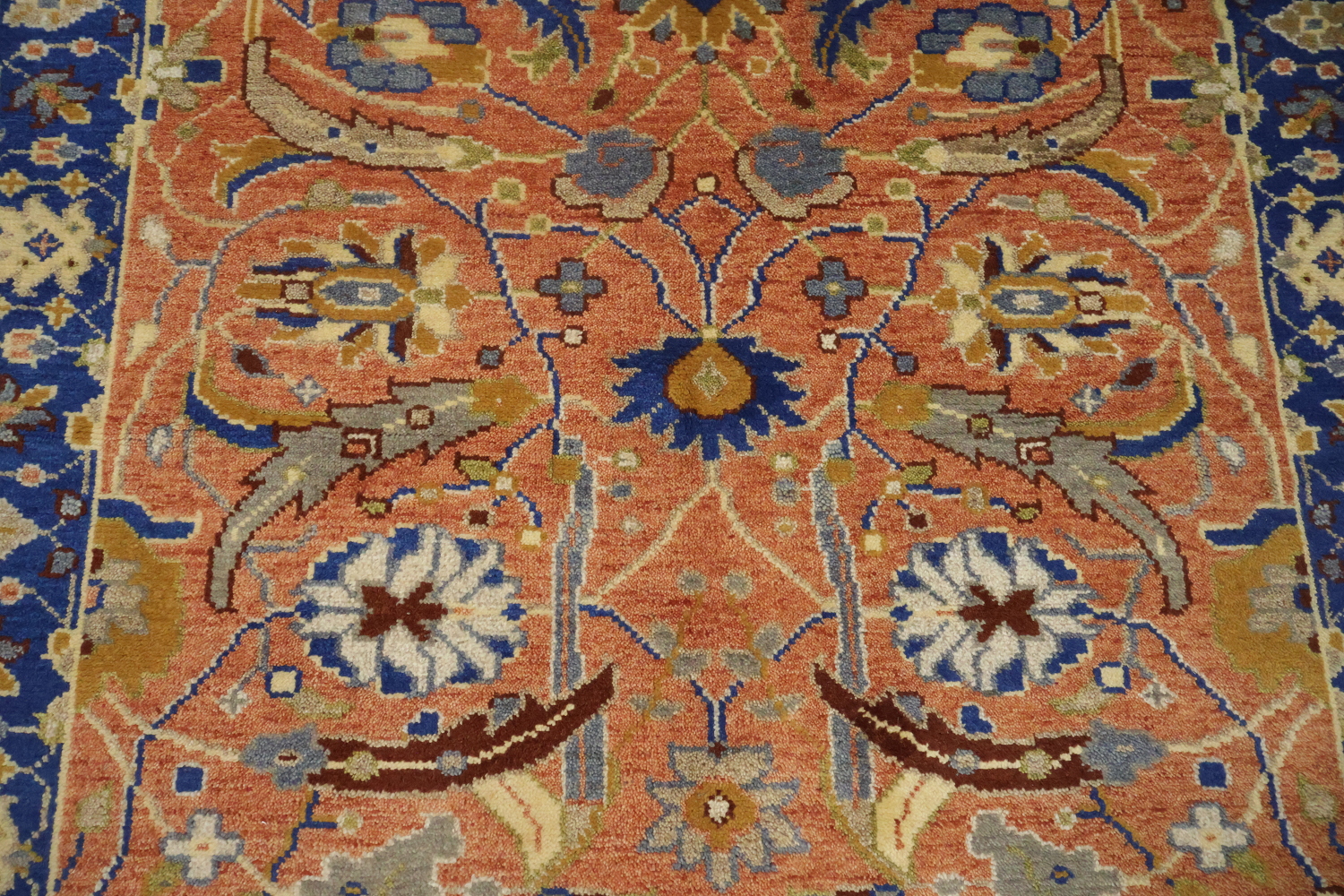 Intricate Floral Orange Rug with Vibrant Blue Border Accent 5'x7'