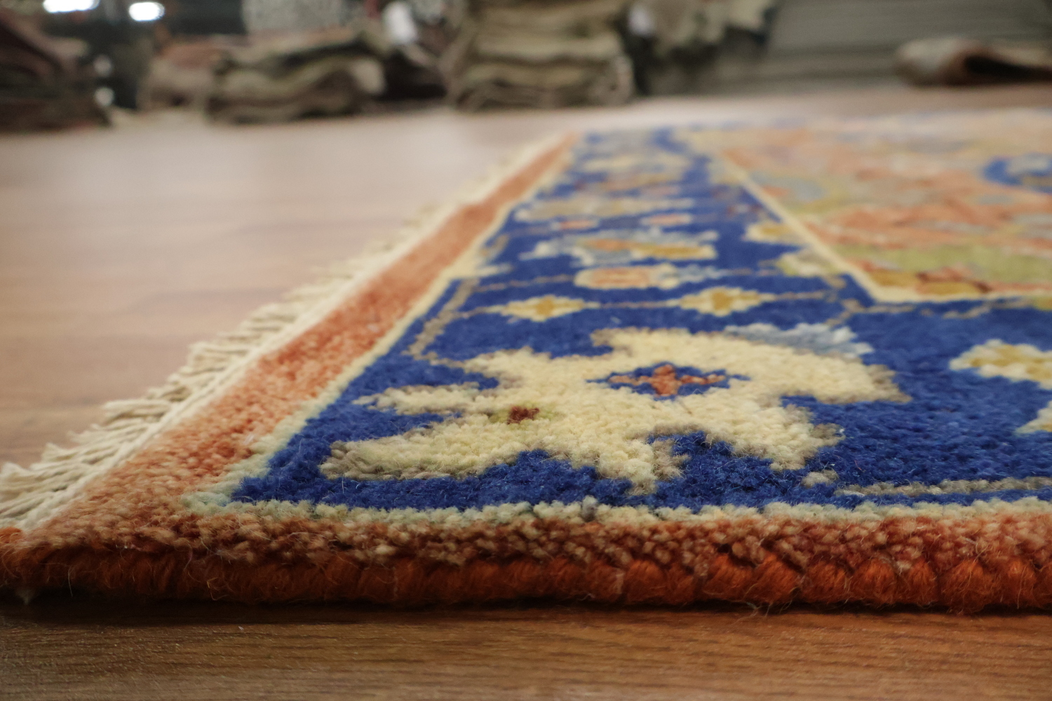 Intricate Floral Orange Rug with Vibrant Blue Border Accent 5'x7'