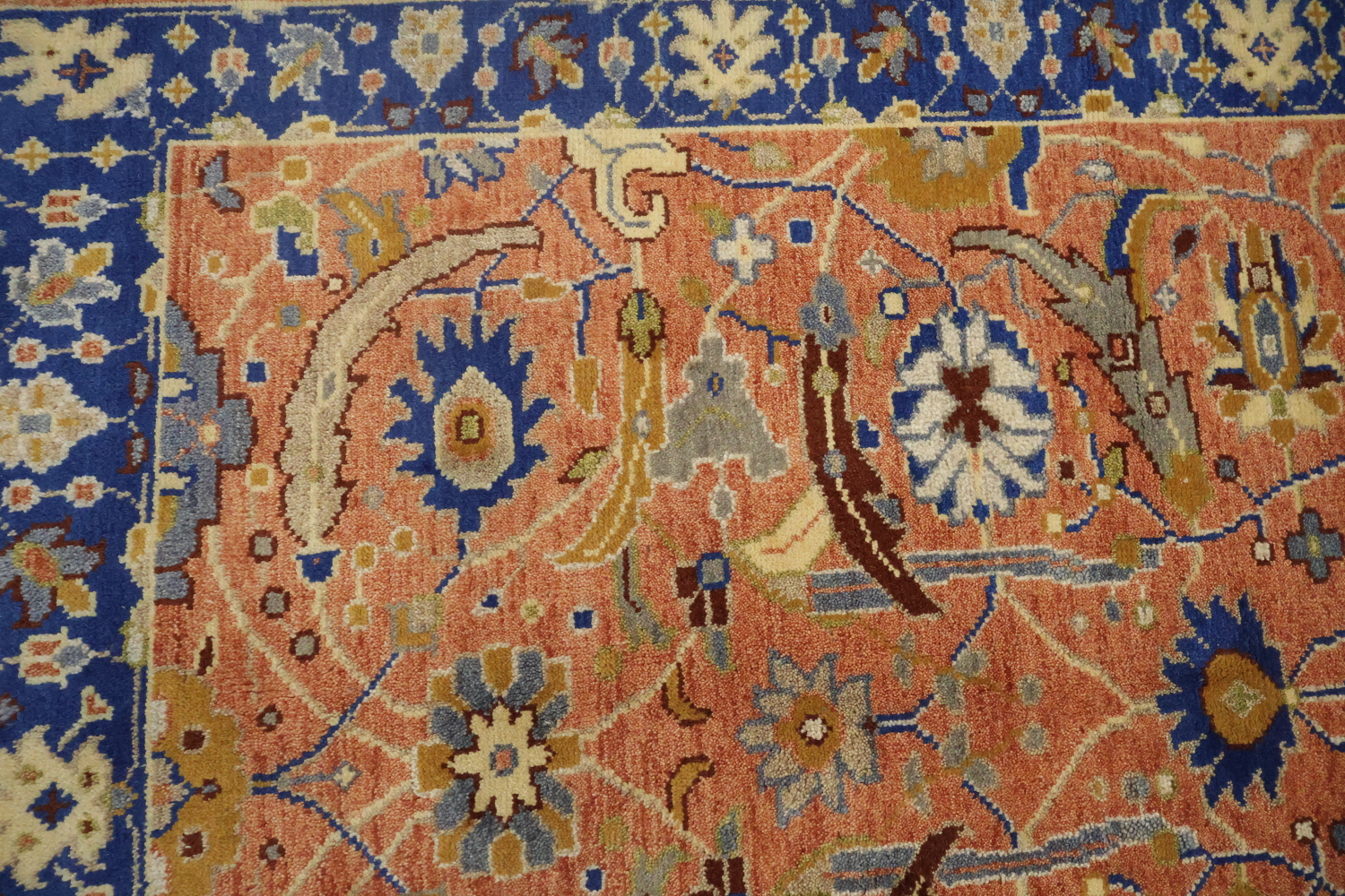 Intricate Floral Orange Rug with Vibrant Blue Border Accent 5'x7'