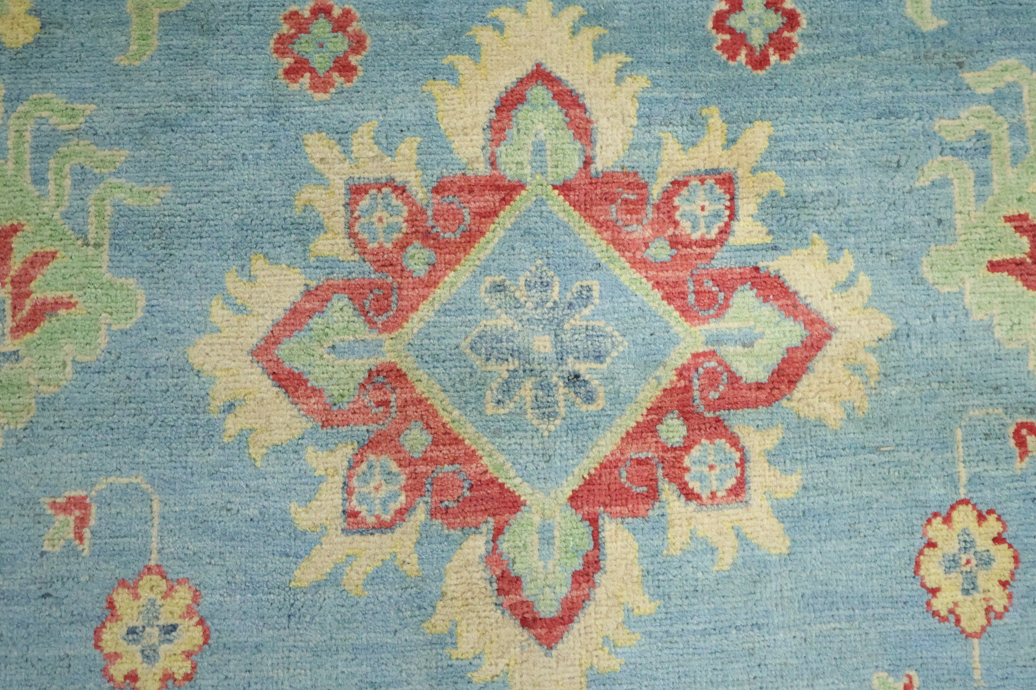 Traditionally designed Kazak Pakistani Rug with blue background 9'x12'