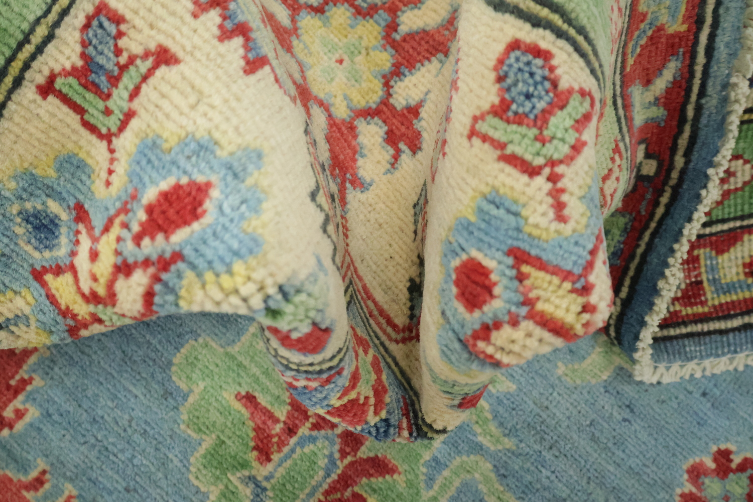 Traditionally designed Kazak Pakistani Rug with blue background 9'x12'