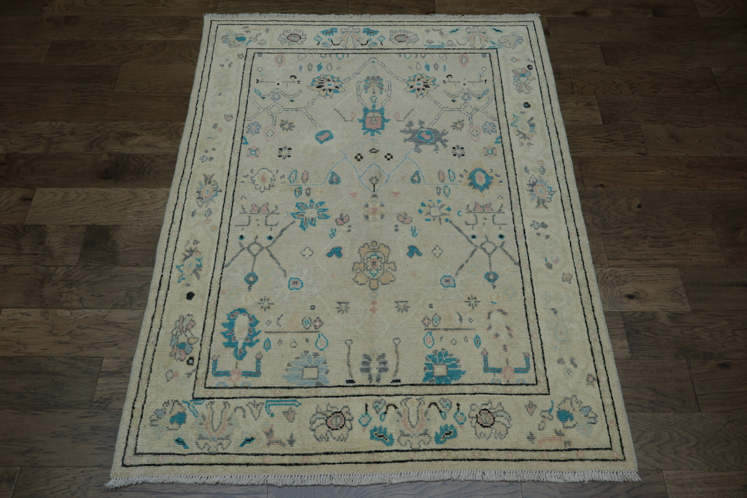 Oushak Turkish Rug with a cream/beige background and blue/turquoise accents 5x6