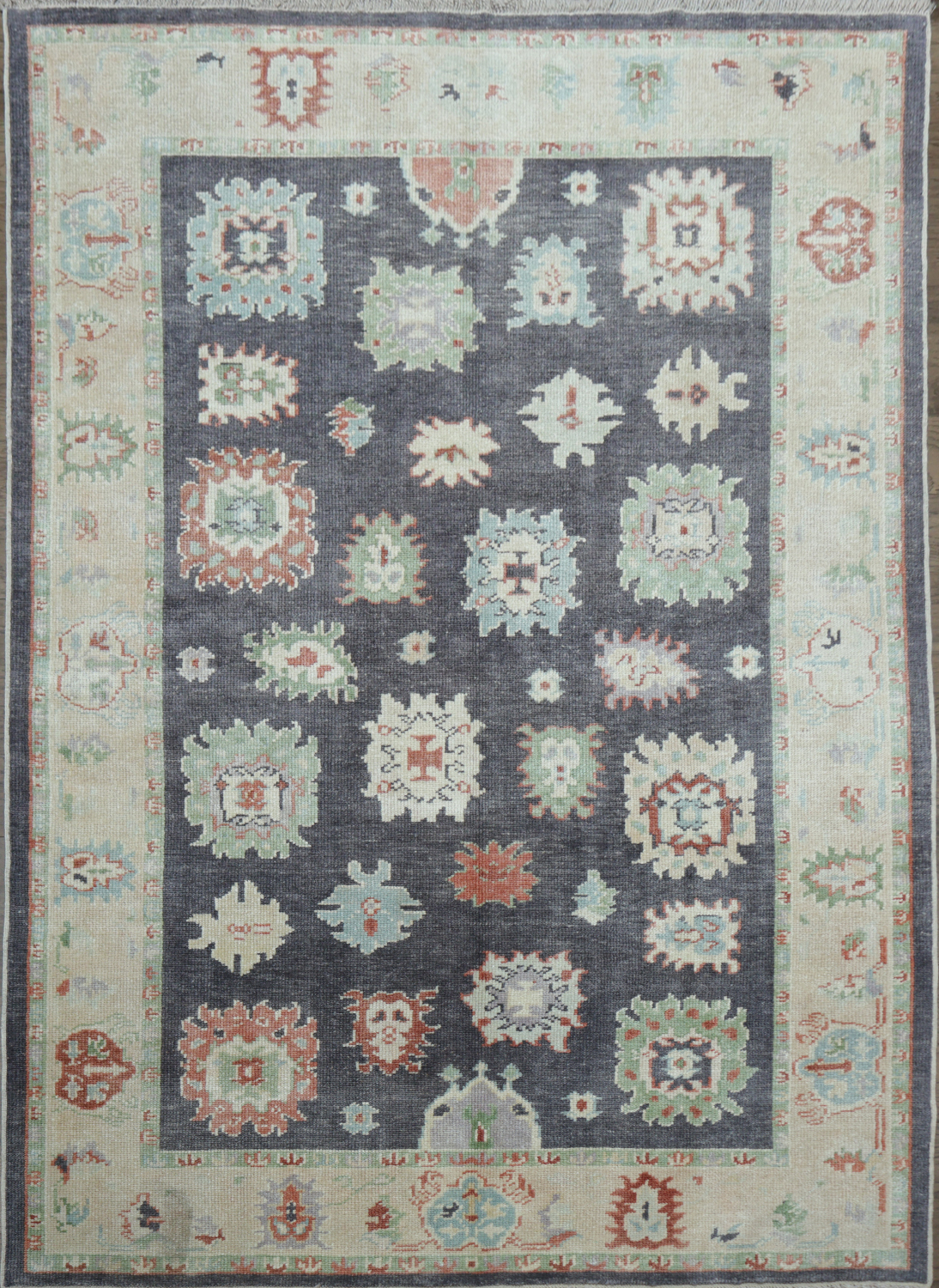 Muted Navy Blue Oushak Turkish Wool Rug with Vibrant Floral Patterns and Border 6x9