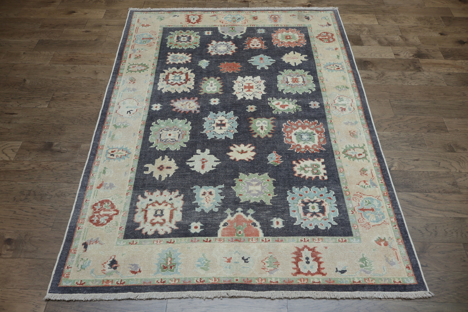 Muted Navy Blue Oushak Turkish Wool Rug with Vibrant Floral Patterns and Border 6x9