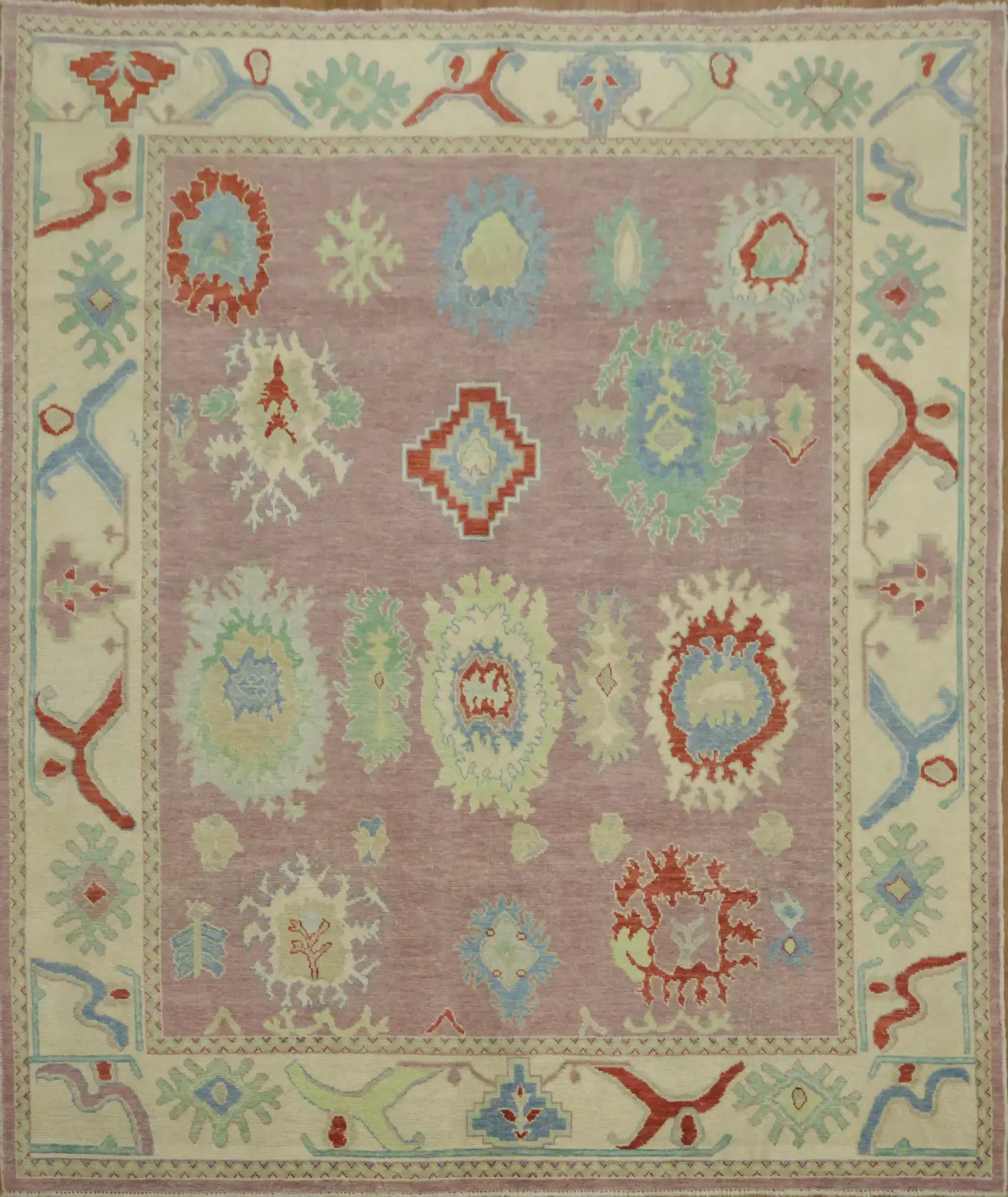 Lavender pink base Oushak Turkish Rug with muted pastel and bold floral motifs 8x10