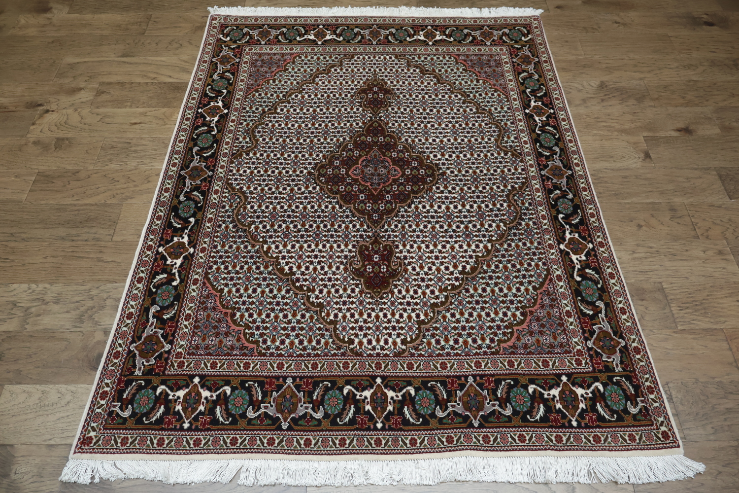 Wool and Silk Persian Tabriz Mahi design Area rug with an ivory field and Black Border 5x7