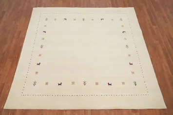 Elegant Beige Gabbeh Area Rug 7x7 Featuring Intricate Animals Border