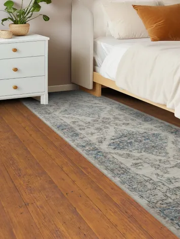 Classic woven rug featuring delicate vintage medallion accents 3x8