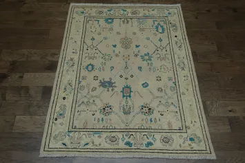 Oushak Turkish Rug with a cream/beige background and blue/turquoise accents 5x6