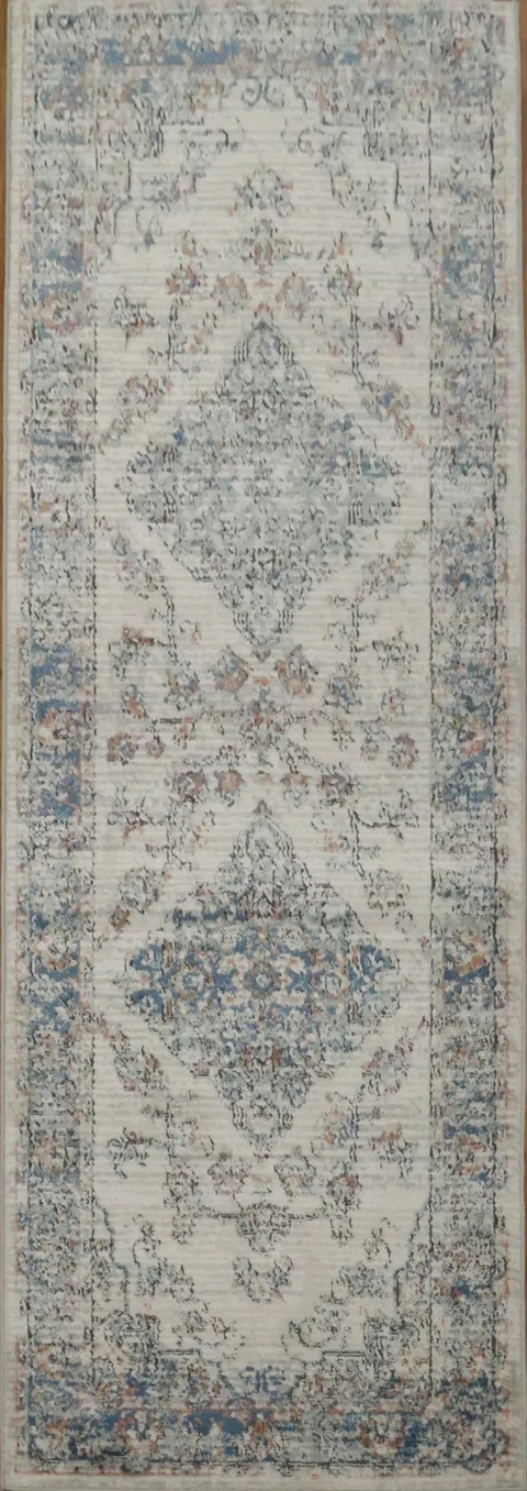 Classic woven rug featuring delicate vintage medallion accents 3x8